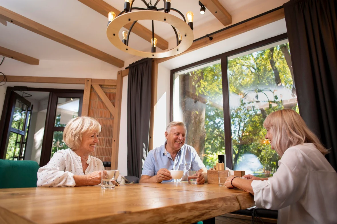 Elderly client enjoying coffee at home with Vitalcare Support